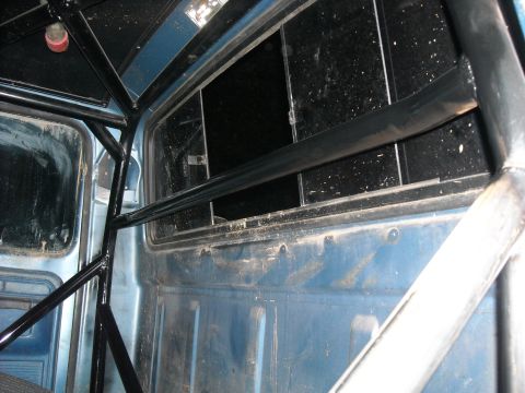 1979 Ford F-150 - The interior of the truck shows a custom roll cage structure installed for safety or racing purposes.