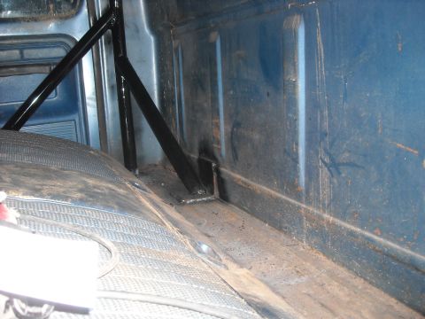 1979 Ford F-150 - Interior view of a truck bed showing a roll cage and worn flooring.
