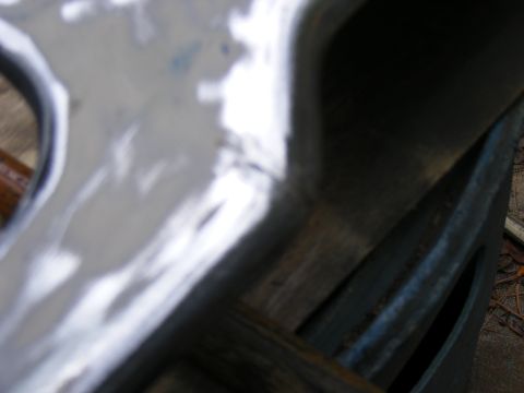 1978 Ford Bronco - This image shows a close-up view of a vehicle's frame and suspension components, with some dirt and debris visible.