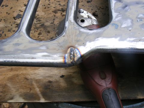 1978 Ford Bronco - A close-up view of a metal part being worked on with a power tool.