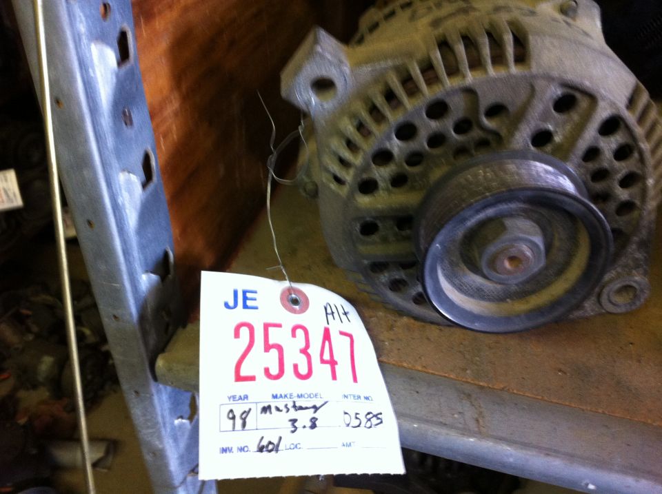 Used alternator on shelf with salvage tag 25347 marked 98 Mustang 3.8