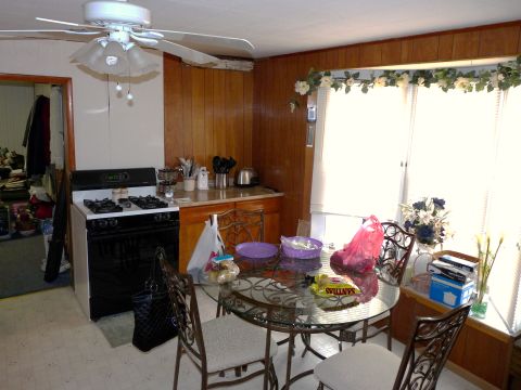 2006 Ford E350 - Interior view of a kitchen area with a stove and dining set.