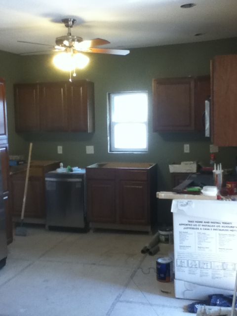 2006 Ford E350 - A kitchen is shown during a renovation, with cabinets installed and a dishwasher visible.