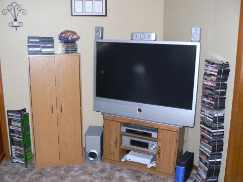 2006 Ford E350 - A living room scene with a television, media console, and storage cabinets filled with DVDs.