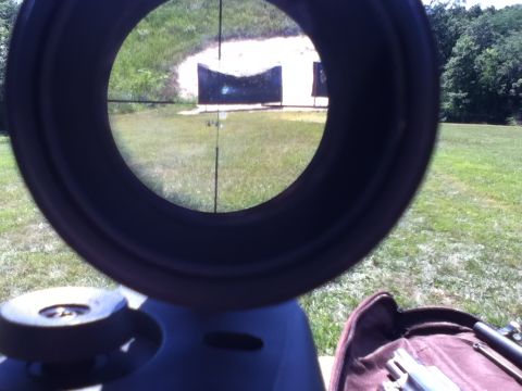 2006 Ford E350 - Aiming at targets through a rifle scope on a sunny day at the shooting range.