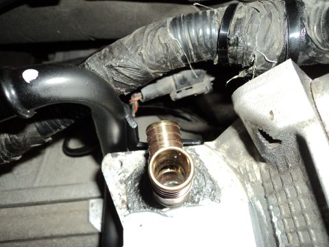 2004 Mercury Grand Marquis - Close-up of an engine component with a brass fitting and electrical connectors.