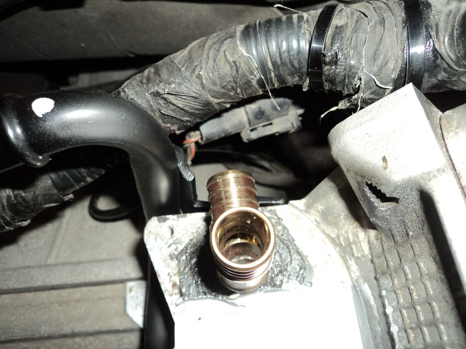 Engine part with brass fitting and wiring harness