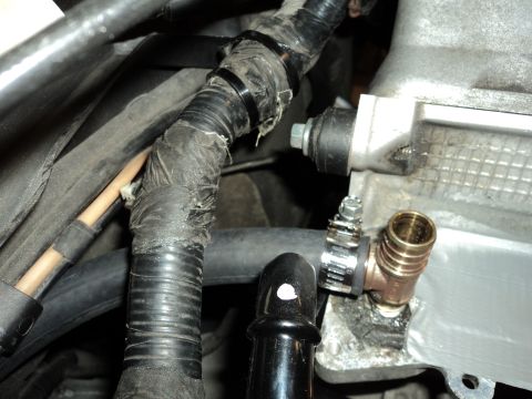 2004 Mercury Grand Marquis - Close-up of engine bay wiring and plumbing, showing a brass T-fitting attached to a hose.