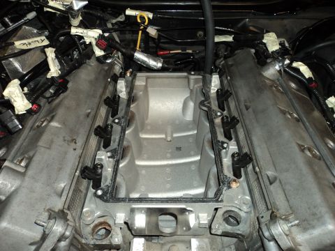 2004 Mercury Grand Marquis - Close-up view of an engine's intake manifold and fuel injectors during a repair or modification.