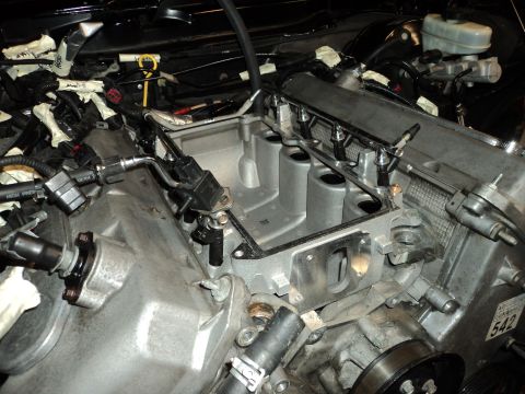 2004 Mercury Grand Marquis - Close-up view of an engine's intake manifold and fuel system components during a repair or modification.
