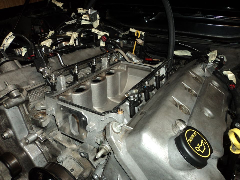 Engine bay with intake manifold removed, showing fuel injectors and wiring