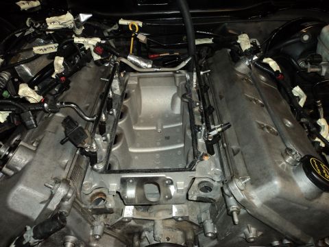2004 Mercury Grand Marquis - Engine bay during intake manifold removal, exposing internal components and wiring harnesses.