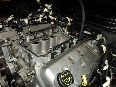 2004 Mercury Grand Marquis - Close-up view of an engine with various components and wiring, some parts are labeled with tape.