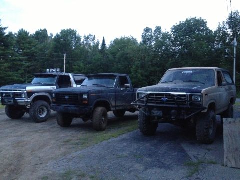 1979 Ford Bronco with custom bumper, parked with two Ford trucks
