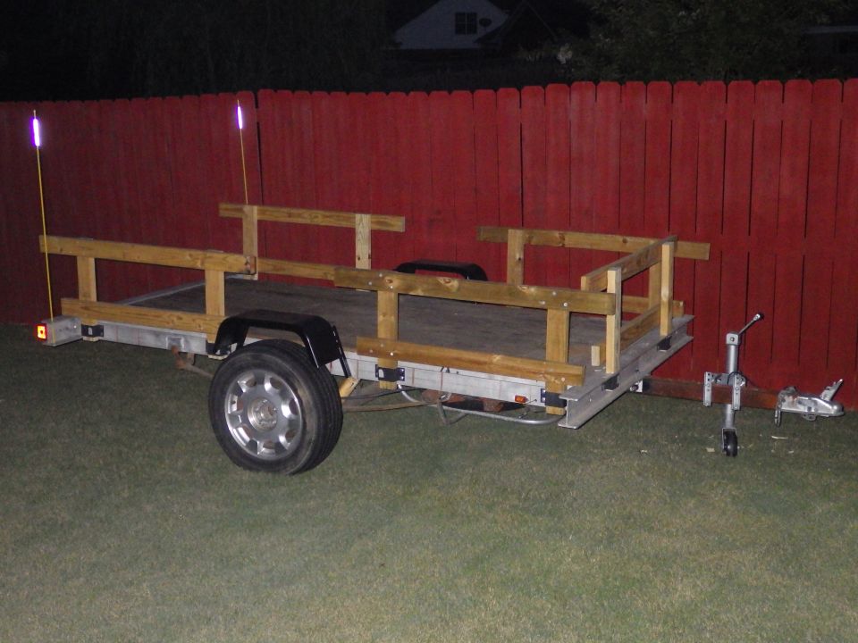 The stake pockets are spaced the same, so these rails fit in any position.

The fiberglass reflective whips make the trailer visible behind most trucks.  Without them, it disappears even behind my Bronco.

I still haven't figured out the e-brake handle.