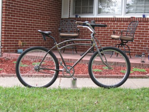 1994 Ford Bronco - A custom bicycle with a unique frame design is parked on a sidewalk in front of a brick house.
