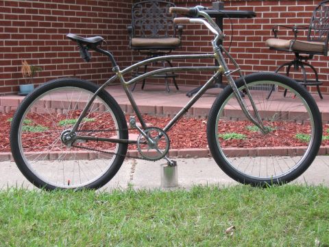 1994 Ford Bronco - A custom cruiser bicycle with a unique frame design and wide tires is parked outdoors.