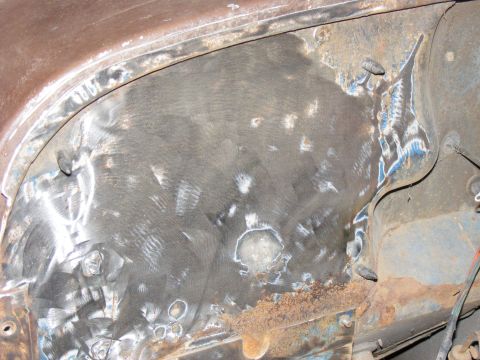 1978 Ford Bronco - This image shows a heavily rusted metal panel with visible weld repairs and grinding marks.