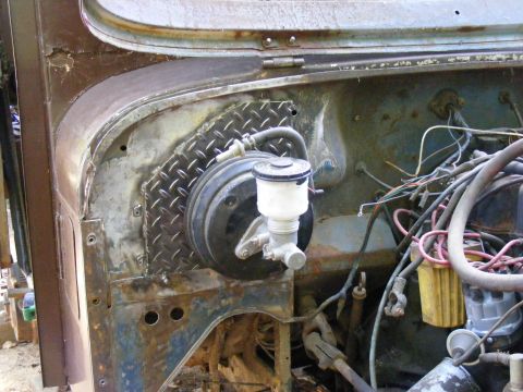1978 Ford Bronco - Close-up view of the engine bay reveals a brake booster and master cylinder assembly.