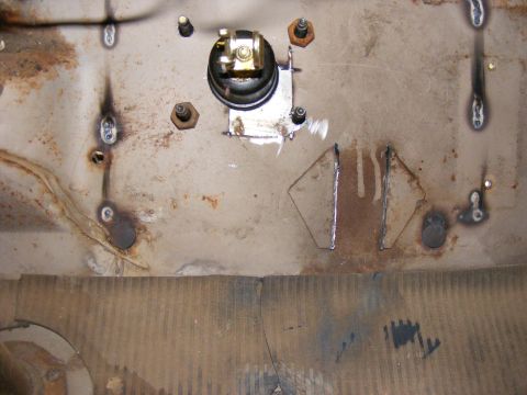 1978 Ford Bronco - This image shows a section of a vehicle's firewall with some electrical components and visible welding marks.