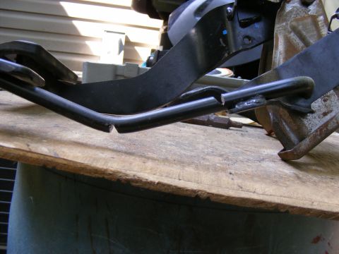 1978 Ford Bronco - This metal part appears to be broken and is resting on a wooden surface.
