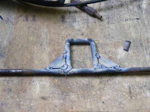 1978 Ford Bronco - A close-up view of a custom-welded metal part, possibly for a vehicle, with the Supermotors logo visible at the bottom right.
