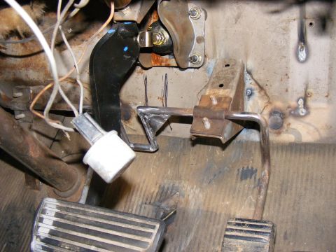 1978 Ford Bronco - The photo shows the interior footwell of a vehicle, focusing on the pedals and associated mechanical components.