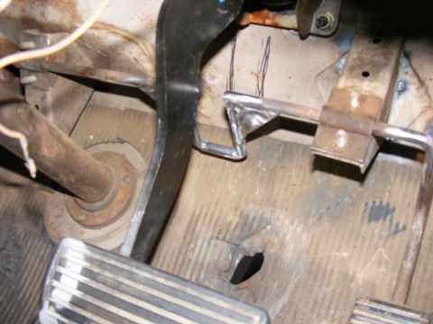 1978 Ford Bronco - Close-up view of the pedals and floor of a vehicle, showing signs of wear and modification.