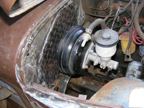 1978 Ford Bronco - Close-up of the brake booster and master cylinder assembly within a vehicle's engine compartment.