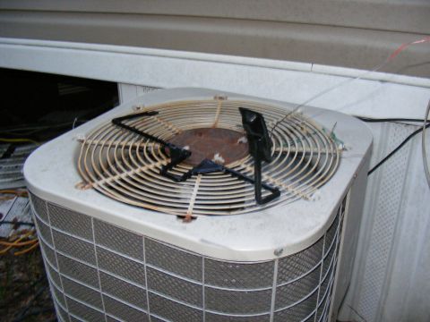 1978 Ford Bronco - Outdoor AC unit fan showing rust and a protective cage over the blades.