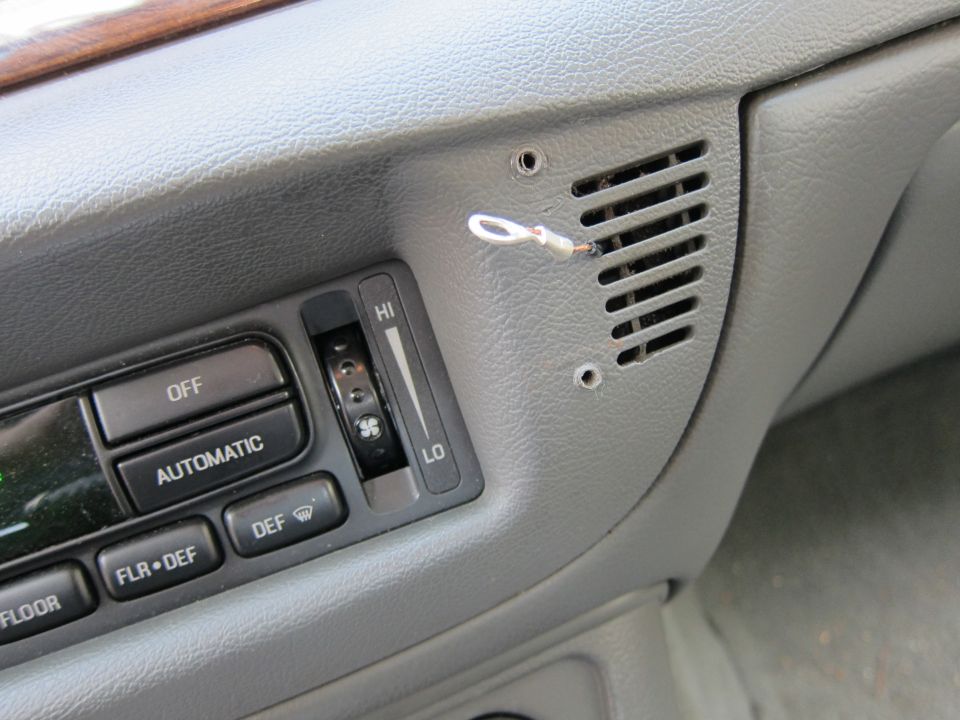 Close-up of a car's dashboard climate controls with buttons for OFF, AUTOMATIC, DEF, FLR+DEF, and a slider for HI/LO fan speed