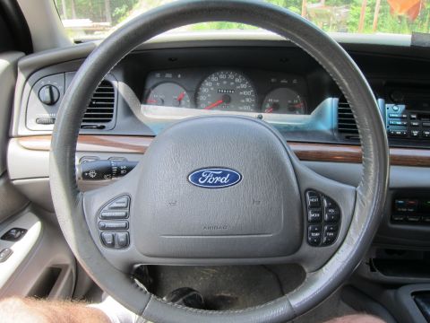 2001 Ford Crown Victoria - Interior view of a 2001 Ford Crown Victoria, showing the steering wheel and dashboard.