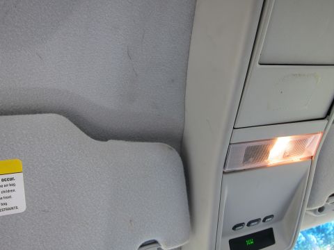 2001 Ford Crown Victoria - The interior overhead console features an illuminated light and several buttons, with a digital display below.