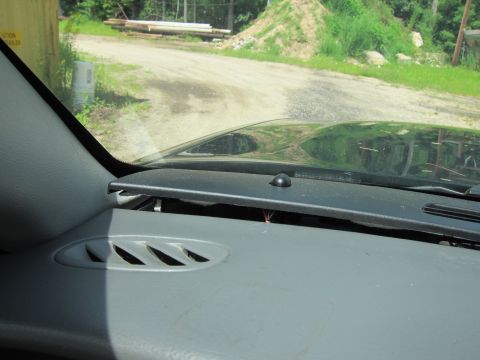 2001 Ford Crown Victoria - Interior view of a vehicle's dashboard with a view of the outside through the windshield.
