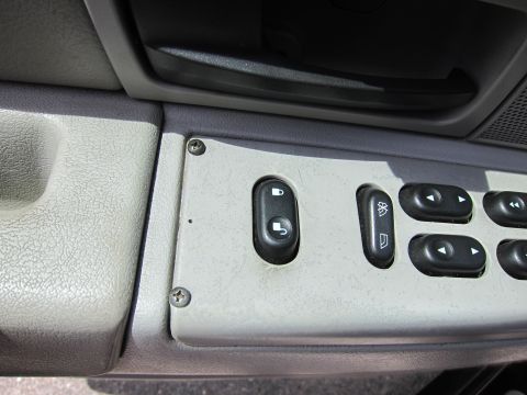 2001 Ford Crown Victoria - Close-up of a car's interior door panel showing power window and lock controls.