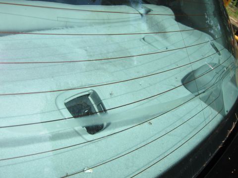 2001 Ford Crown Victoria - Interior view of a car's rear window, showing defroster lines and trim.