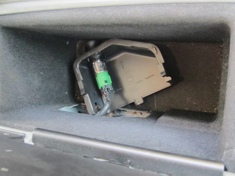 2001 Ford Crown Victoria - A close-up view of an interior automotive part a green electrical connector and some visible text.