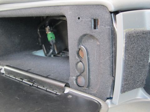 2001 Ford Crown Victoria - Close-up of the inside of a glove compartment with visible wiring and a green connector.