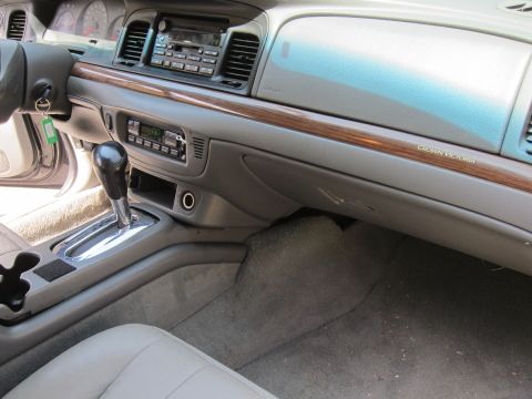 2001 Ford Crown Victoria - The interior of a 2001 Ford Crown Victoria is visible, the dashboard and center console.