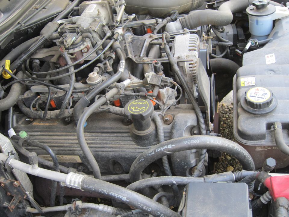 Engine bay with visible hoses and engine components. Parker hoses are visible