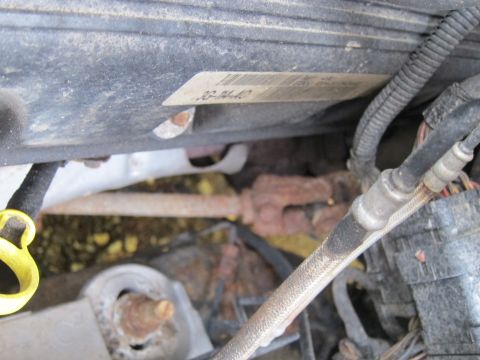 2001 Ford Crown Victoria - Close-up view of an engine compartment, showing a label with the text "J3-04-40" and various hoses and wiring.