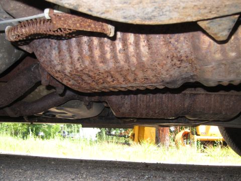 2001 Ford Crown Victoria - Rusty exhaust system components visible on the underside of a vehicle.