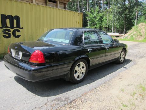 2001 Ford Crown Victoria - Rear 3/4 view of a black 2001 Ford Crown Victoria sedan.