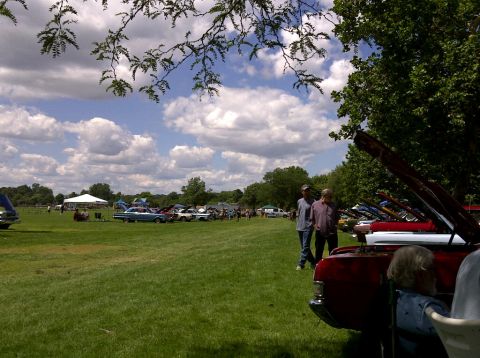 1971 Ford Ranchero - People gather at a car show with numerous vehicles on display in an open field.