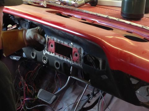 1964 Ford Fairlane - Work is underway on the dashboard of a 1964 Ford Fairlane, with exposed wiring and metal fabrication visible.