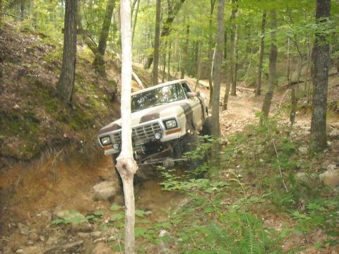1979 Ford F-150 - Ford F-150 climbs a rocky, wooded trail during an off-road excursion.