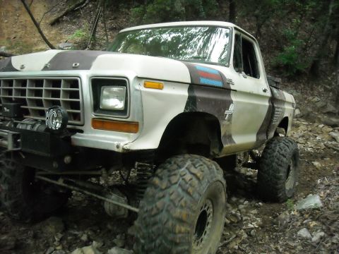 1979 Ford F-150 - A lifted 1979 Ford F-150 pickup truck with custom paint sits on a rocky trail.