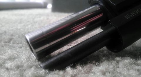 2000 Mercury Grand Marquis - A close-up view of a firearm barrel, showing some engraved text and a shiny metal finish.