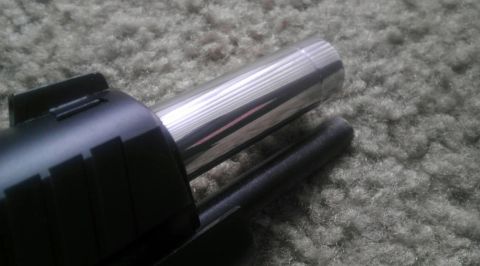 2000 Mercury Grand Marquis - A close-up view of a chrome exhaust tip, likely a replacement part, against a carpeted background.