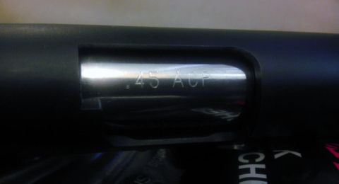 2000 Mercury Grand Marquis - The image shows a close-up of a firearm's slide with the caliber '.45 ACP' clearly engraved.